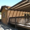 little straw bale building with big deck
