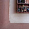 Close up of the edge of a clay plastered niche done in two colors.