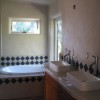 A contemporary bathroom with clay plastered walls