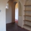 Clay plaster on soft arches and built in shelves.