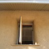A deep set window in a straw bale wall.