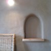A nicho carved into a bale wall, plastered in clay.