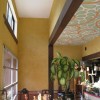 Bright clay plastered walls and a hand=painted mural on the ceiling.