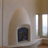 A clay plastered beehive fireplace.