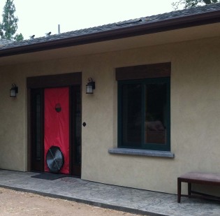 A blower door test being preformed on a straw bale home to test air tightness.