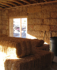 A tightly stacked straw bale wall before plaster.